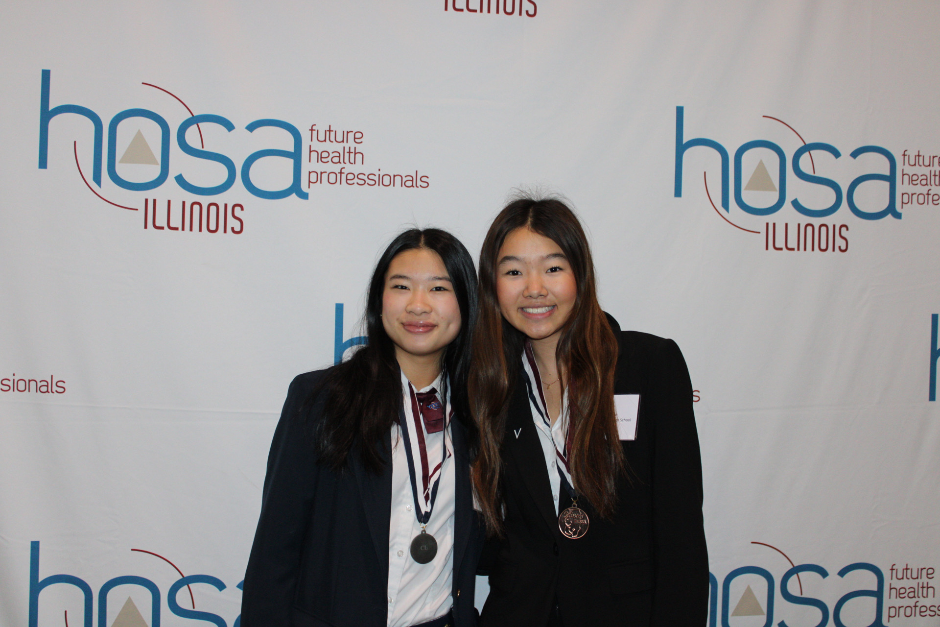 Two members pose with their medals at the Illinois HOSA State Leadership Conference
